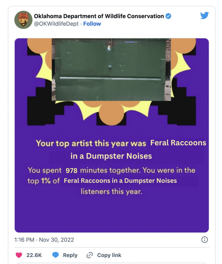 A screenshot of a tweet from @OKWildlifeDept that features a Spotify Wrapped graphic. The text on the graphic reads, 'Your top artist this year was Feral Raccoons in a Dumpster Noises. You spent 978 minutes together. You were in the top 1% of Feral Raccoons in a Dumpster Noises listeners this year.'